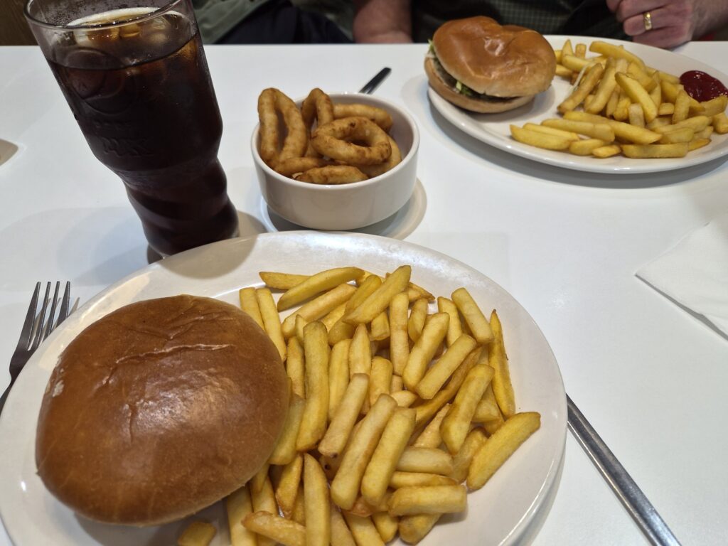 wimpy burger with chips and onion rings and a cola drink