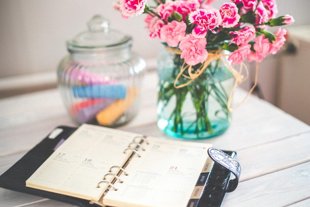 diary with vase of flowers