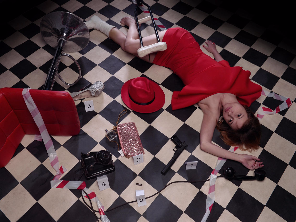 set of a murder mystery dinner with dead body surrounded by evidence