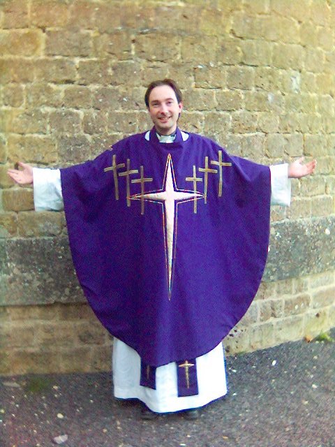 An Anglican priest wearing a chasuble over alb and stole. Author Gareth Hughes