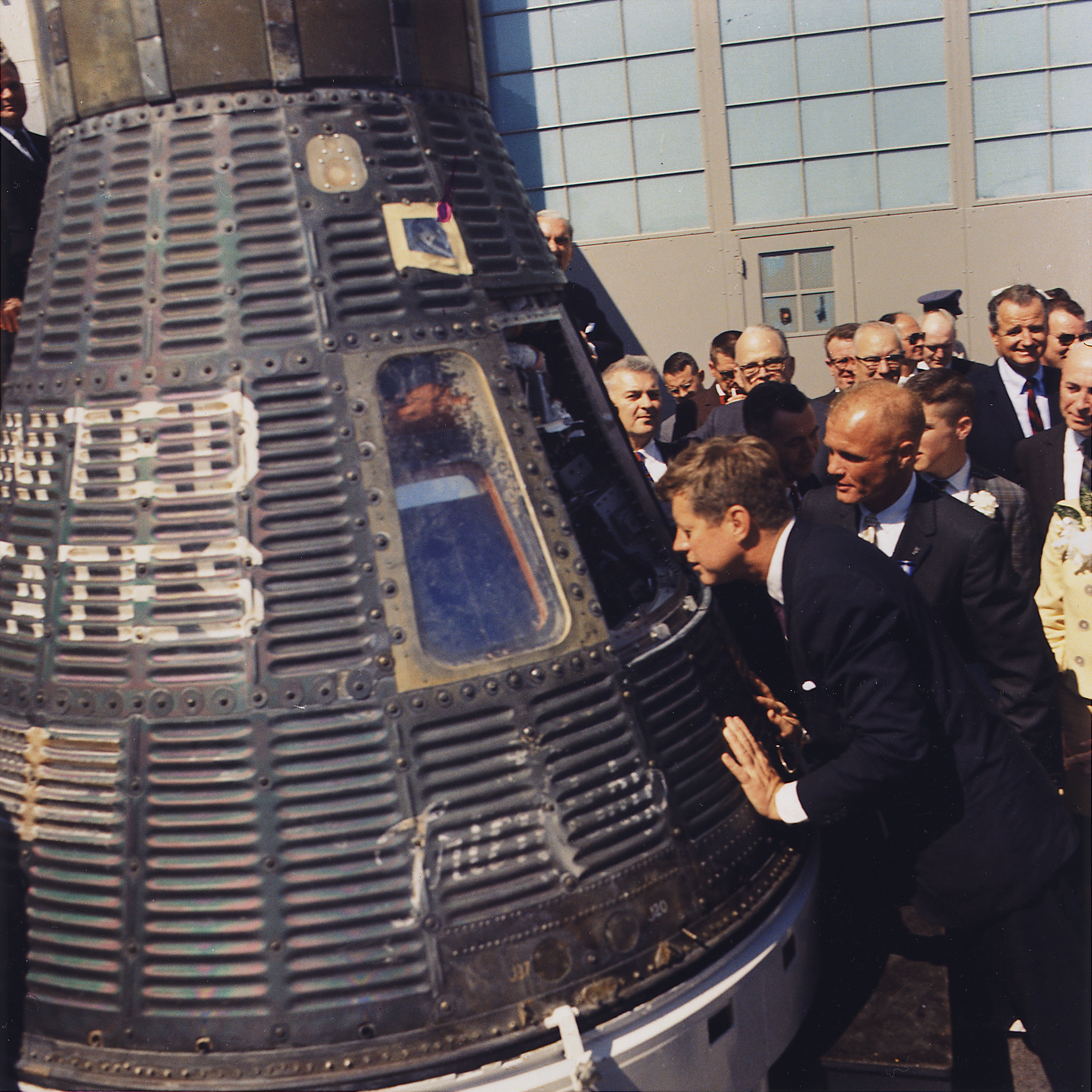 https://commons.wikimedia.org/wiki/File:JFK_inspects_Mercury_capsule,_23_February_1962.jpg