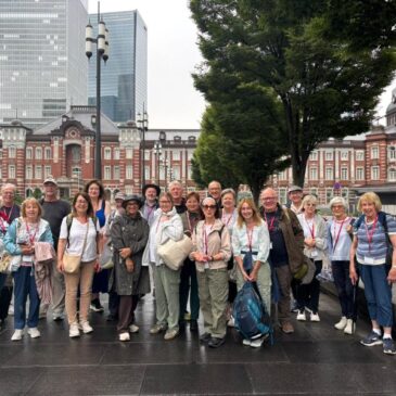 Group tourists pose for photo in Japan