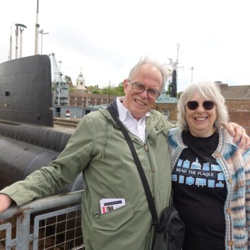 Man and woman standing by submarine
